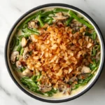 A comforting dish featuring green beans, creamy sauce, and fried onions